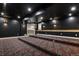 View of theater room with platform seating and doorway leading to a bright, open area at 16250 Kenosha St, Brighton, CO 80603