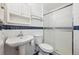 Classic bathroom featuring a pedestal sink, toilet, and shower with glass doors, all with blue and white tile at 6007 Yarrow St # I, Arvada, CO 80004