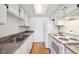 Functional kitchen featuring clean white cabinetry, granite countertops, and modern appliances at 6007 Yarrow St # I, Arvada, CO 80004