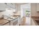 Clean kitchen with essential appliances and a view into a bright, airy living space, promoting seamless living at 6007 Yarrow St # I, Arvada, CO 80004