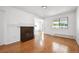 Bright living room with hardwood floors, a cozy fireplace, and large windows offering ample natural light at 6007 Yarrow St # I, Arvada, CO 80004