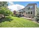 Large backyard with lush green grass, well-maintained fence and patio furniture at 8548 Winter Berry Dr, Castle Pines, CO 80108
