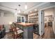 Basement bar with wood countertop, mini fridge, and stacked stone backsplash at 8548 Winter Berry Dr, Castle Pines, CO 80108