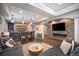 Basement with stone fireplace, dry bar, and comfortable gray sectional seating at 8548 Winter Berry Dr, Castle Pines, CO 80108