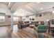 Basement living area with gray sectional sofa, hardwood floors, and recessed lighting at 8548 Winter Berry Dr, Castle Pines, CO 80108