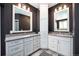 Bathroom featuring double sinks, gray cabinets, and a tall linen closet at 8548 Winter Berry Dr, Castle Pines, CO 80108