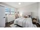 Bedroom with light gray walls, plush rug, and neutral patterned bedding at 8548 Winter Berry Dr, Castle Pines, CO 80108