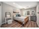 Cozy bedroom with wood floors, stylish furnishings, and plenty of natural light from the window at 8548 Winter Berry Dr, Castle Pines, CO 80108