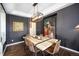 Contemporary dining room featuring stylish furnishings, an art piece, and dark walls for elegant meals at 8548 Winter Berry Dr, Castle Pines, CO 80108