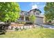 Charming gray two-story home with a manicured lawn and inviting front porch in a well-maintained community at 8548 Winter Berry Dr, Castle Pines, CO 80108