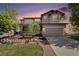 Charming two-story home with well-manicured lawn, mature trees, and a spacious driveway at 8548 Winter Berry Dr, Castle Pines, CO 80108