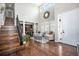 Bright, open foyer featuring hardwood floors, a staircase, and an inviting view into the adjacent living spaces at 8548 Winter Berry Dr, Castle Pines, CO 80108