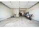 Spacious three-car garage with ample room for parking and storage, including stairs to upper level at 8548 Winter Berry Dr, Castle Pines, CO 80108