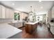 Bright kitchen features a spacious island, modern appliances, and an open layout to the dining area at 8548 Winter Berry Dr, Castle Pines, CO 80108
