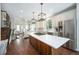 Expansive kitchen with stainless steel appliances, a large island, and an open view to the living room at 8548 Winter Berry Dr, Castle Pines, CO 80108