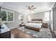 Serene main bedroom boasts abundant natural light, a tray ceiling, and neutral decor at 8548 Winter Berry Dr, Castle Pines, CO 80108
