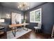 Office with dark gray walls, wood desk, and white trim window at 8548 Winter Berry Dr, Castle Pines, CO 80108