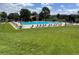 Community pool with lounge chairs, tables, and lawn at 8548 Winter Berry Dr, Castle Pines, CO 80108