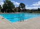 Large community swimming pool with bath house, tables, and lounge chairs at 8548 Winter Berry Dr, Castle Pines, CO 80108