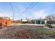 This backyard features a shed, chicken coop, vintage lawnmower and full perimeter fence at 1250 S Tennyson St, Denver, CO 80219