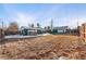 Expansive backyard featuring a shed, chicken coop and fenced perimeter with a blend of dormant grass and patchy snow at 1250 S Tennyson St, Denver, CO 80219