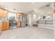 Open kitchen with stainless steel appliances, light wood cabinets, and seamless flow into the living area at 1250 S Tennyson St, Denver, CO 80219