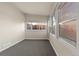 Cozy sun room offers ample natural light and neutral tones, creating a relaxing space with plush gray carpeting at 1250 S Tennyson St, Denver, CO 80219