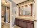 Bathroom featuring a double sink vanity with tile counters, a shower and toilet at 14193 E Radcliff Cir, Aurora, CO 80015