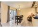 Charming dining room featuring tile floors, patio access, and adjacent kitchen at 14193 E Radcliff Cir, Aurora, CO 80015