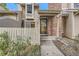 Welcoming townhome featuring a fenced entry, brick chimney, and well-maintained landscaping at 14193 E Radcliff Cir, Aurora, CO 80015