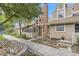Charming townhome exterior with brick chimney, lovely landscaping, and inviting walkway at 14193 E Radcliff Cir, Aurora, CO 80015