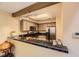 Modern kitchen with granite countertops, stainless steel appliances, and ample cabinetry at 14193 E Radcliff Cir, Aurora, CO 80015