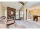 Inviting living room features wood floors, brick fireplace, and dining area access at 14193 E Radcliff Cir, Aurora, CO 80015