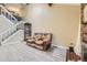 Light filled living room showcases wood floors, open staircase, and a brick fireplace at 14193 E Radcliff Cir, Aurora, CO 80015