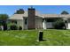 Manicured backyard featuring a brick chimney, lush green lawn, and private outdoor space at 13908 E Linvale Pl, Aurora, CO 80014