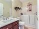 Well-lit bathroom with marble countertop, a walk in bathtub and decorative plant at 13908 E Linvale Pl, Aurora, CO 80014