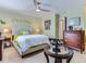 Spacious bedroom with a decorative wall piece and a large dresser at 13908 E Linvale Pl, Aurora, CO 80014