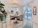 Bright dining area with patio access adjacent to a modern kitchen at 13908 E Linvale Pl, Aurora, CO 80014