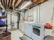 Functional laundry room with modern washer and dryer units, and storage space, offering convenience at 13908 E Linvale Pl, Aurora, CO 80014