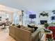 Comfortable living room with a white brick fireplace, modern furniture, and lots of light at 13908 E Linvale Pl, Aurora, CO 80014