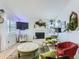 Cozy living room featuring a white fireplace, large TV, and comfortable seating at 13908 E Linvale Pl, Aurora, CO 80014