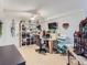 Craft room with ceiling fan, large shelving unit, and an entertainment area at 13908 E Linvale Pl, Aurora, CO 80014