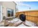 Backyard patio area with grill, outdoor dining area, and a wooden fence providing privacy at 14204 E Baltic Cir, Aurora, CO 80014