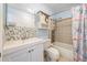 Clean bathroom with white vanity, shower, and decorative tile at 14204 E Baltic Cir, Aurora, CO 80014