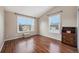 Simple bedroom with wood flooring and large windows at 14204 E Baltic Cir, Aurora, CO 80014