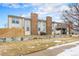 Rear view of the home showcasing its brick facade and deck at 14204 E Baltic Cir, Aurora, CO 80014