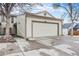 Exterior view of a two-car garage with a concrete driveway on a cloudy day at 14204 E Baltic Cir, Aurora, CO 80014