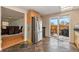 Kitchen with tile floor, stainless steel refrigerator, sliding glass door to back patio and dining room view at 14204 E Baltic Cir, Aurora, CO 80014