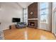 Bright living room features a brick fireplace, wood floors, vaulted ceilings, and large windows at 14204 E Baltic Cir, Aurora, CO 80014