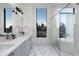 Spa-like bathroom with a freestanding tub, marble finishes, and city views at 1750 Wewatta St # 1940, Denver, CO 80202